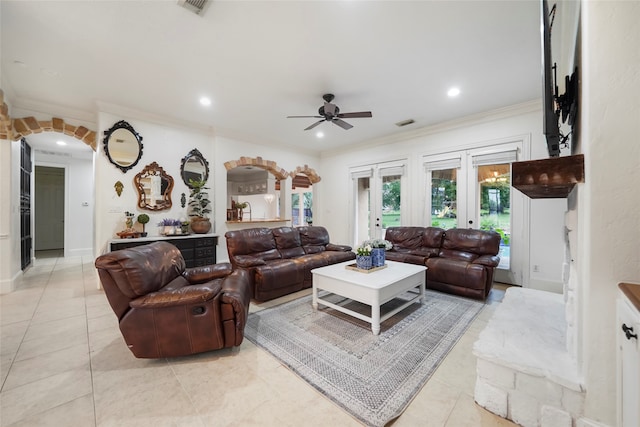 tiled living room with french doors, ceiling fan, and crown molding