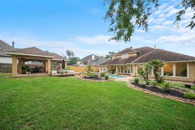 view of yard featuring a gazebo, a fenced in pool, and a patio area