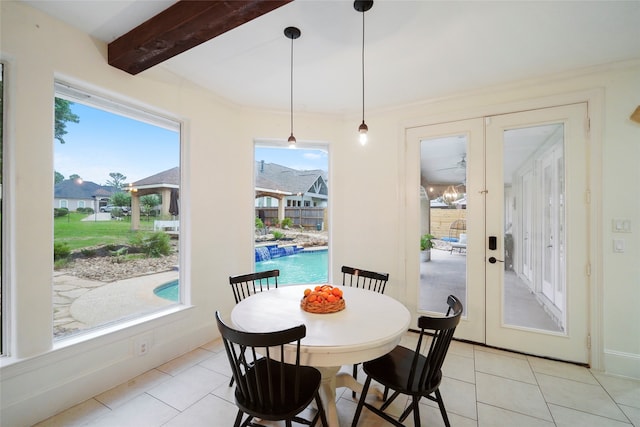 tiled dining space with a wealth of natural light, beamed ceiling, and french doors