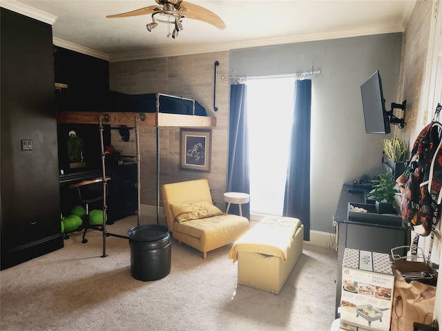 sitting room with ornamental molding, carpet floors, and ceiling fan