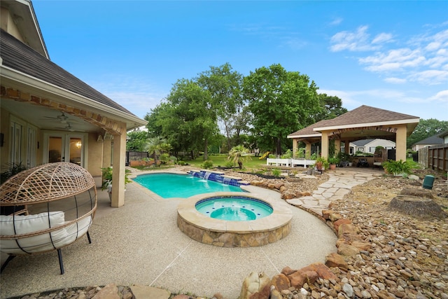 view of swimming pool with a gazebo, an in ground hot tub, a patio area, and ceiling fan