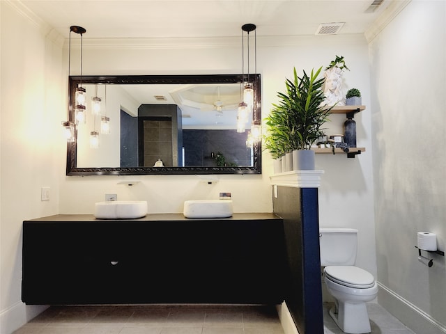 bathroom with vanity, toilet, tile patterned floors, and ornamental molding