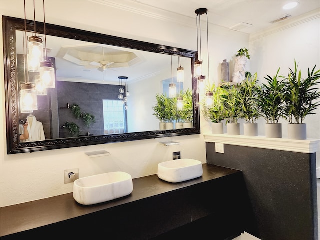 bathroom featuring vanity, crown molding, a tray ceiling, and ceiling fan