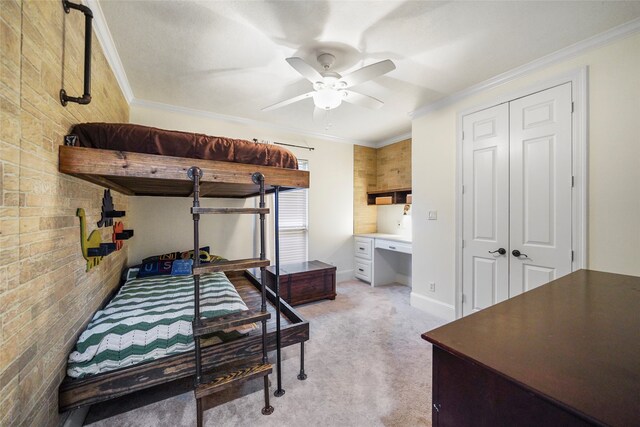 carpeted bedroom featuring a closet, ceiling fan, and ornamental molding