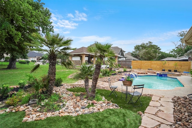 view of swimming pool with pool water feature and a lawn