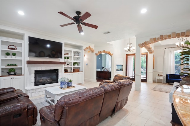 living room featuring ornamental molding, light tile patterned floors, ceiling fan with notable chandelier, and built in shelves