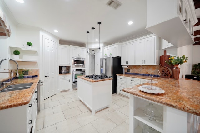 kitchen featuring white cabinets, backsplash, stainless steel appliances, decorative light fixtures, and sink