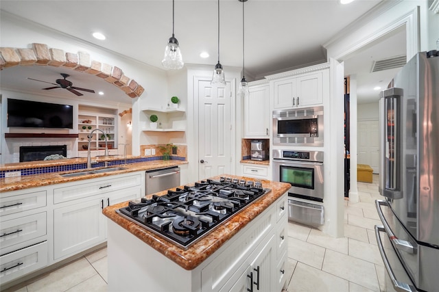 kitchen featuring sink, a center island, stainless steel appliances, and white cabinetry