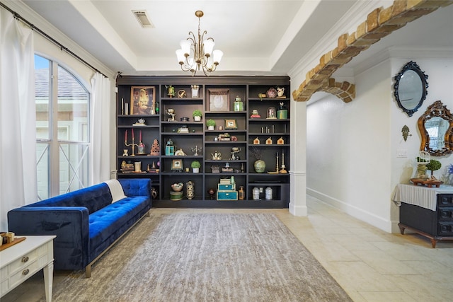 living area featuring tile patterned floors, a chandelier, crown molding, and a raised ceiling