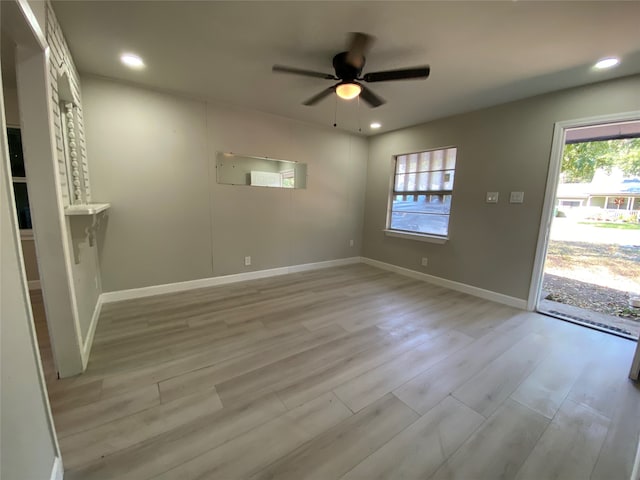 empty room featuring light wood-type flooring and ceiling fan