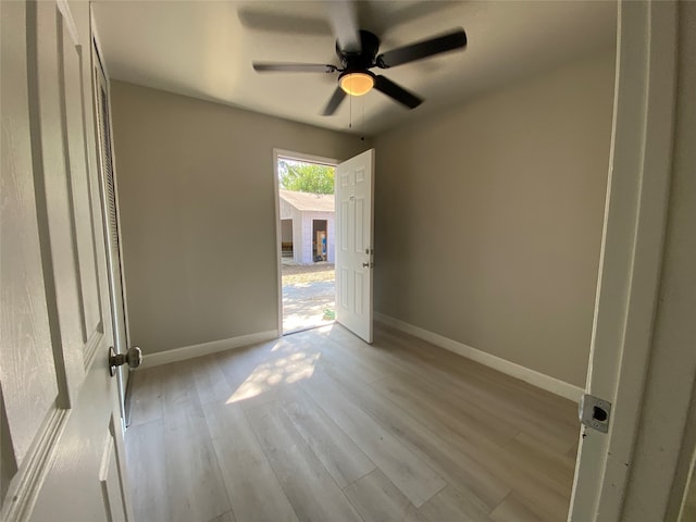 unfurnished room with light hardwood / wood-style flooring and ceiling fan