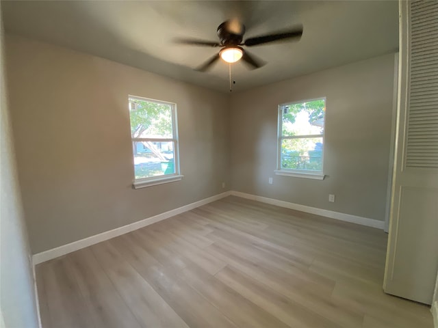 unfurnished bedroom with light hardwood / wood-style floors, multiple windows, and ceiling fan