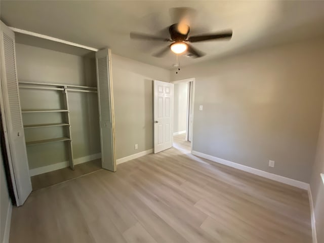 unfurnished bedroom with light hardwood / wood-style flooring, a closet, and ceiling fan