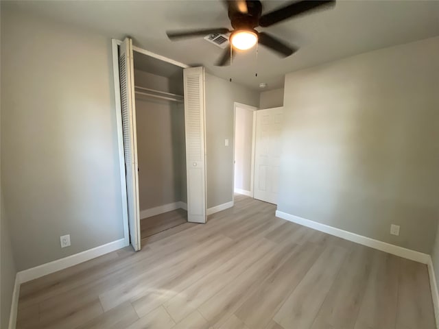 unfurnished bedroom featuring light hardwood / wood-style floors, a closet, and ceiling fan