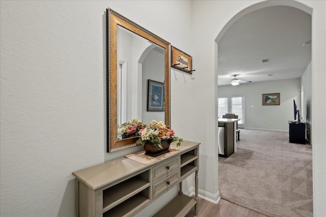 hallway featuring light colored carpet