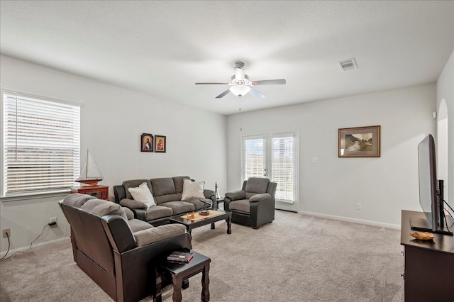 living room with light carpet and ceiling fan