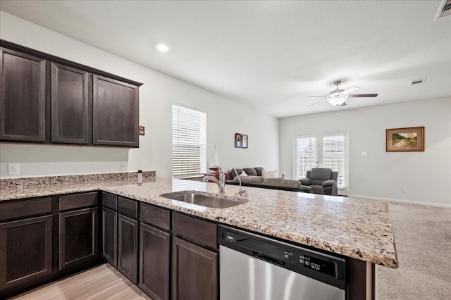 kitchen featuring sink, dishwasher, dark brown cabinets, kitchen peninsula, and light carpet