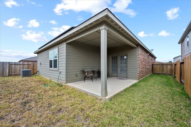 back of house featuring a yard, cooling unit, and a patio