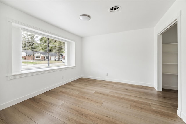 unfurnished room featuring light hardwood / wood-style floors