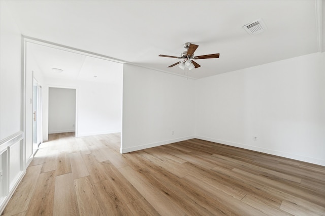 empty room with light hardwood / wood-style floors and ceiling fan