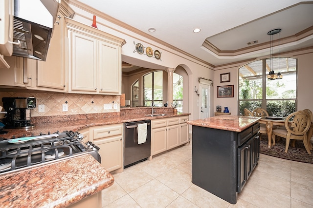 kitchen with stainless steel dishwasher, a center island, light stone counters, and cream cabinets