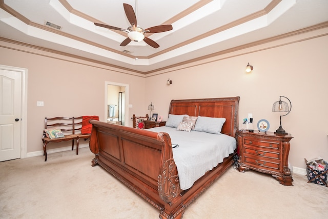 bedroom featuring ceiling fan, a raised ceiling, light colored carpet, and ornamental molding