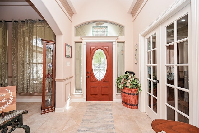 entryway with light tile patterned flooring and french doors