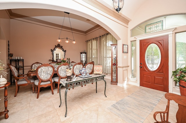 tiled foyer entrance with crown molding