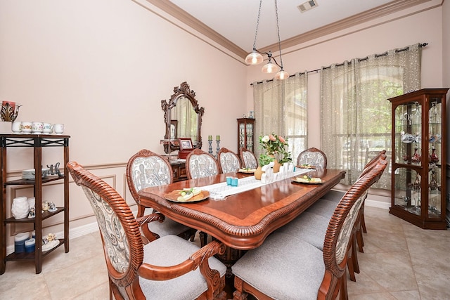 tiled dining room featuring ornamental molding