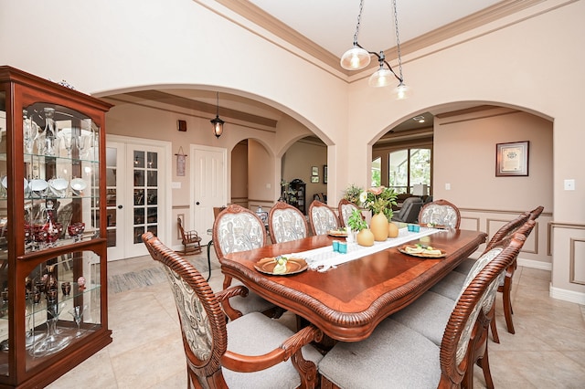 dining space with light tile patterned flooring and crown molding