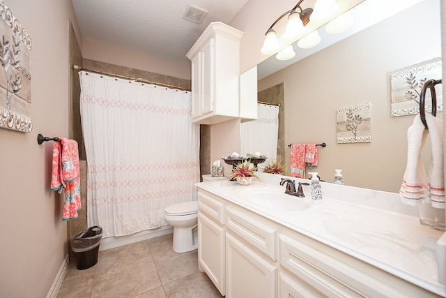 bathroom with tile patterned flooring, vanity, and toilet