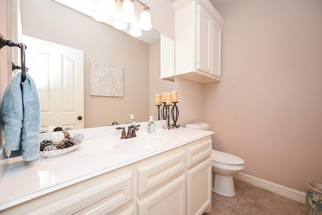 bathroom with tile patterned flooring, vanity, and toilet