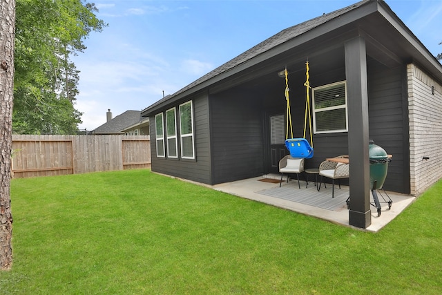 rear view of house featuring a yard