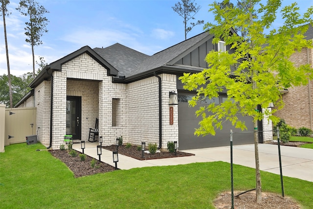 craftsman inspired home featuring a garage and a front lawn