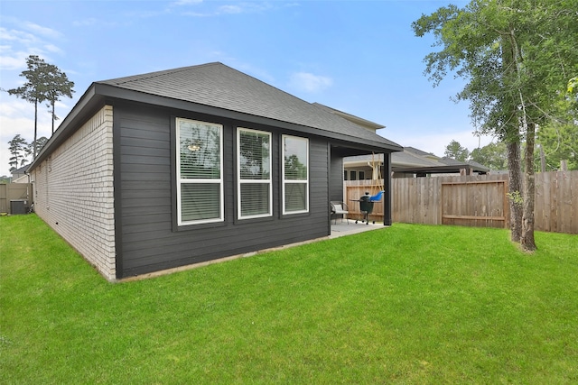 back of property featuring a patio, central air condition unit, and a lawn