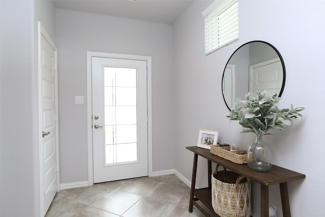 doorway with light tile patterned flooring