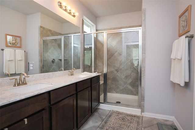 bathroom featuring vanity, a shower with shower door, and tile patterned flooring