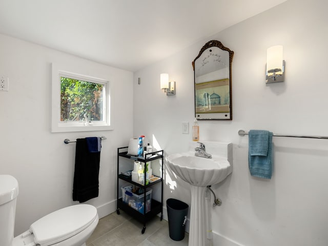 bathroom featuring toilet and tile patterned flooring