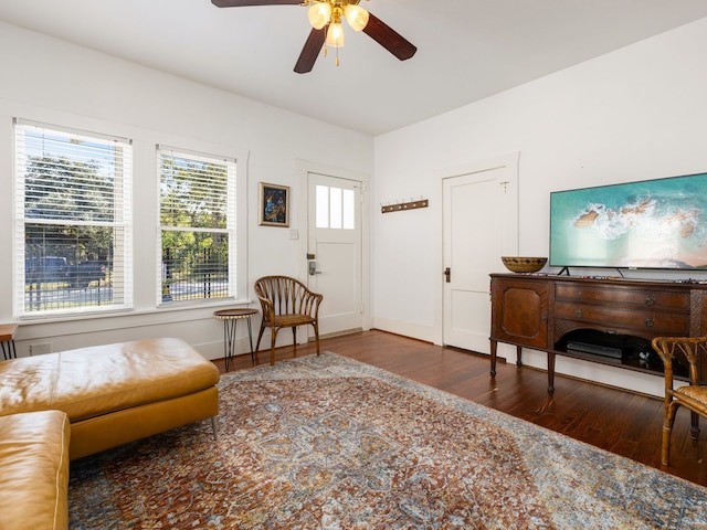 sitting room featuring ceiling fan and dark hardwood / wood-style floors