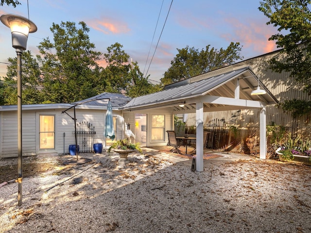 back house at dusk with a patio