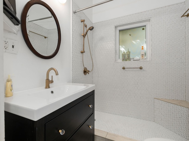 bathroom with vanity and tiled shower