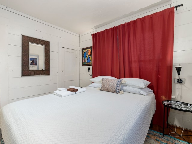 bedroom with wood walls