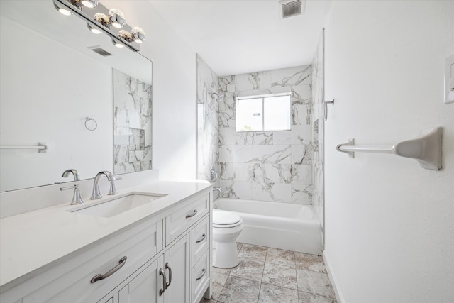 full bathroom featuring toilet, tiled shower / bath, and vanity