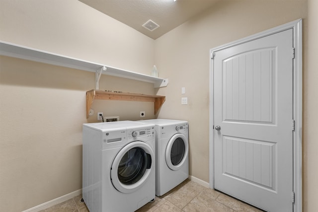 laundry area featuring independent washer and dryer and light tile patterned flooring