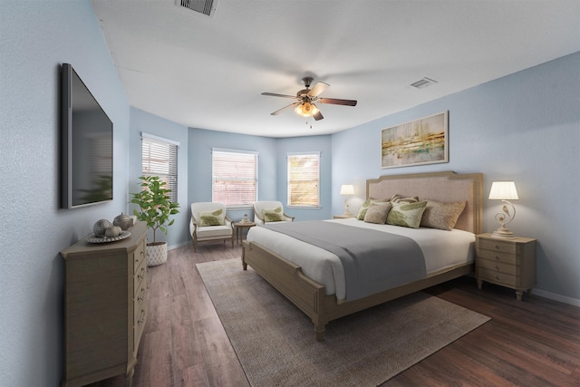 bedroom with ceiling fan and dark hardwood / wood-style floors