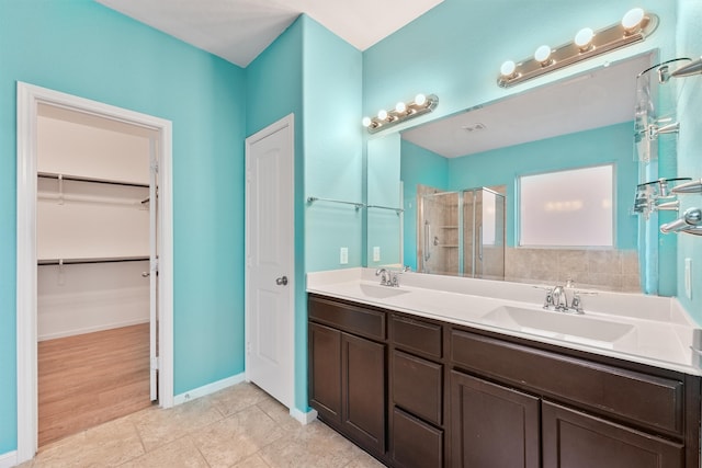 bathroom with hardwood / wood-style floors, vanity, and walk in shower