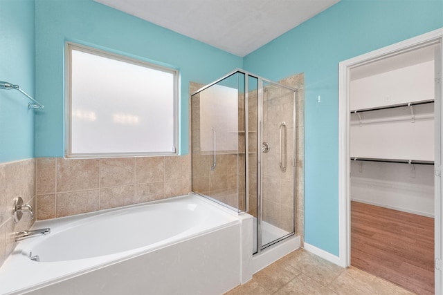 bathroom featuring independent shower and bath and hardwood / wood-style flooring