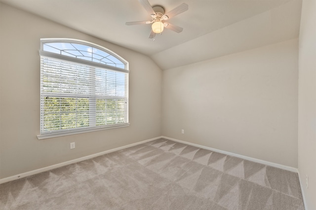 spare room with light carpet, vaulted ceiling, and a healthy amount of sunlight