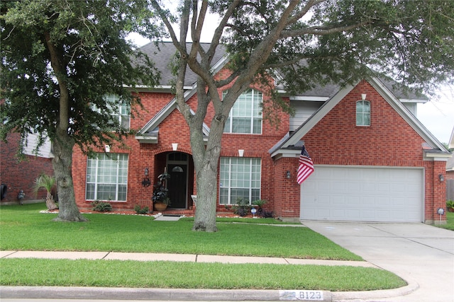 view of property with a front yard and a garage