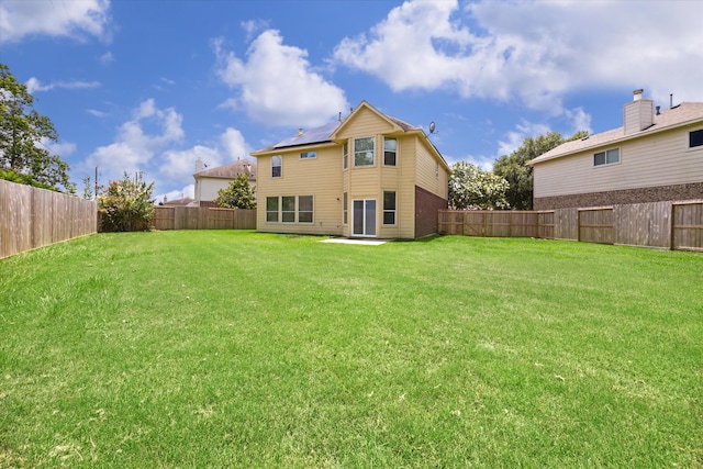 back of property featuring a lawn